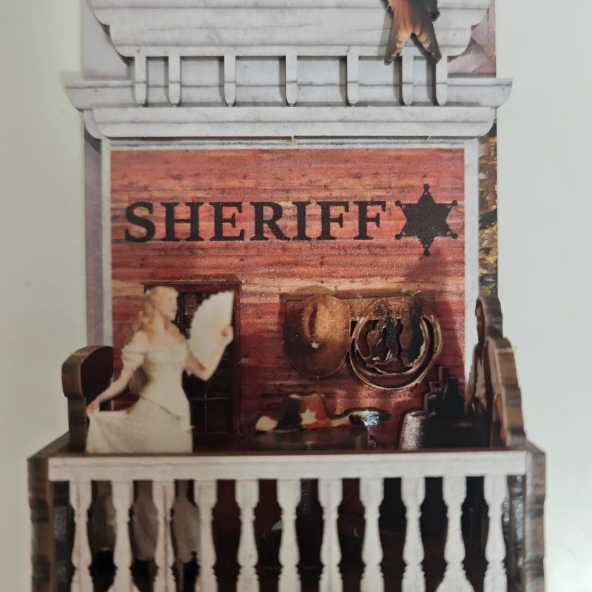 miniature of a sheriff's office with 'SHERIFF' sign and cowboy hat.