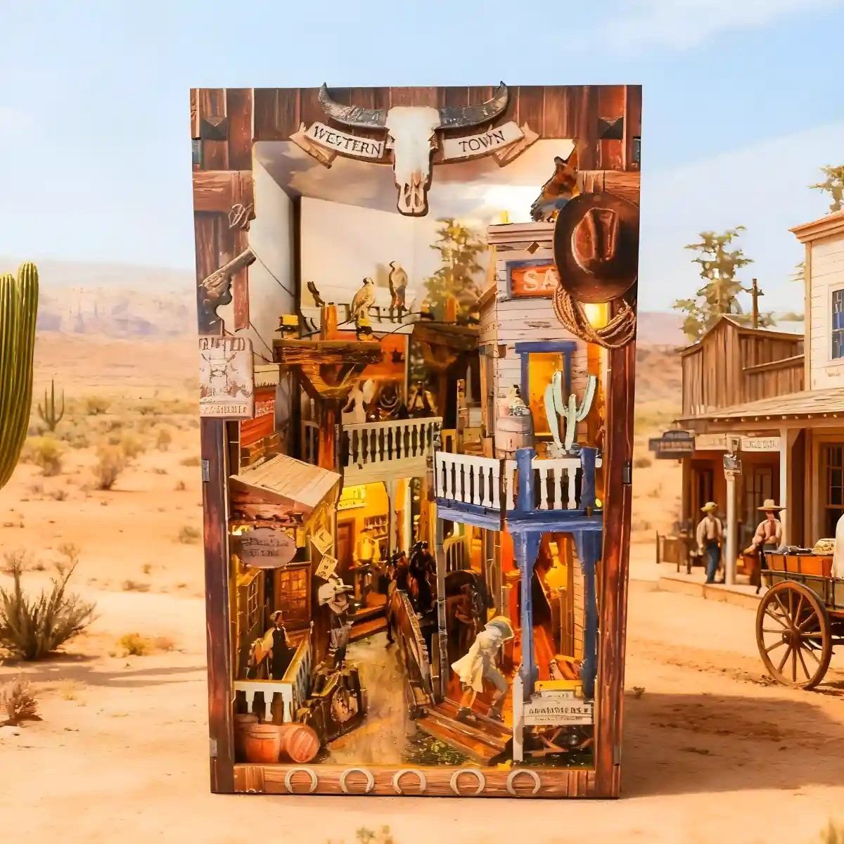 book nook Model of a western town with detailed architecture and figures, set against a desert backdrop.