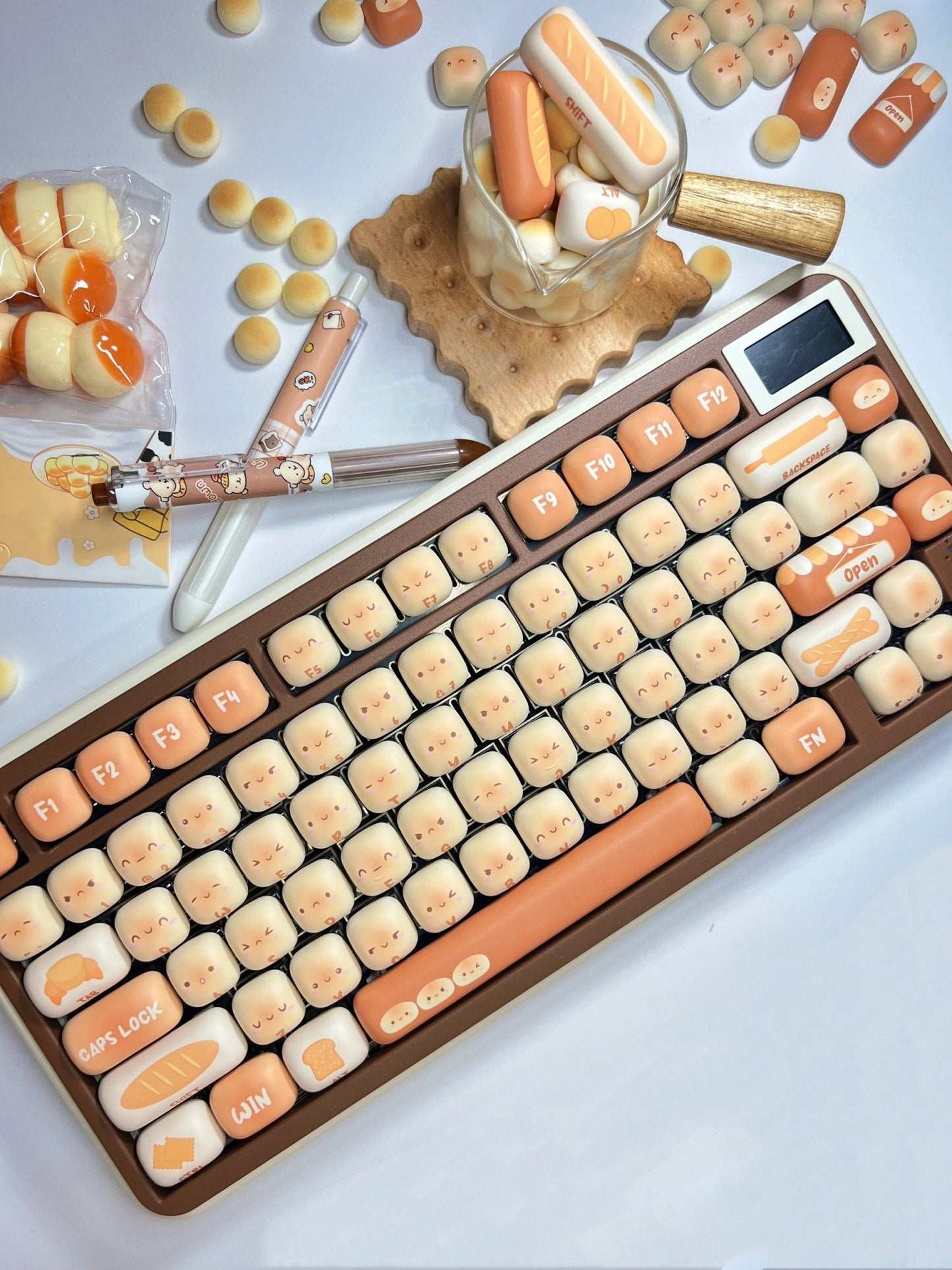 Keyboard with cartoon Toasted Bread keys on a surface with candy-themed items