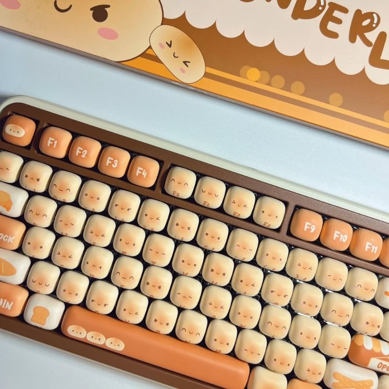 Keyboard with cute face keycaps on a light blue background