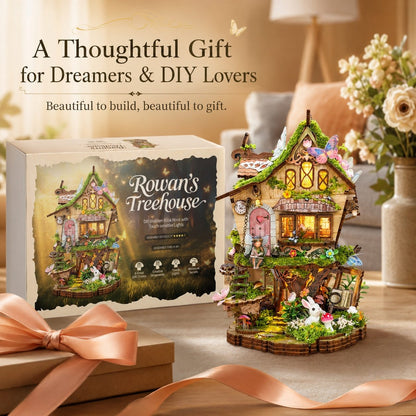 A decorative miniature treehouse building kit shown with its retail box on a tabletop. The box reads 'Rowan's Treehouse' and features an illustrated view of the completed treehouse.