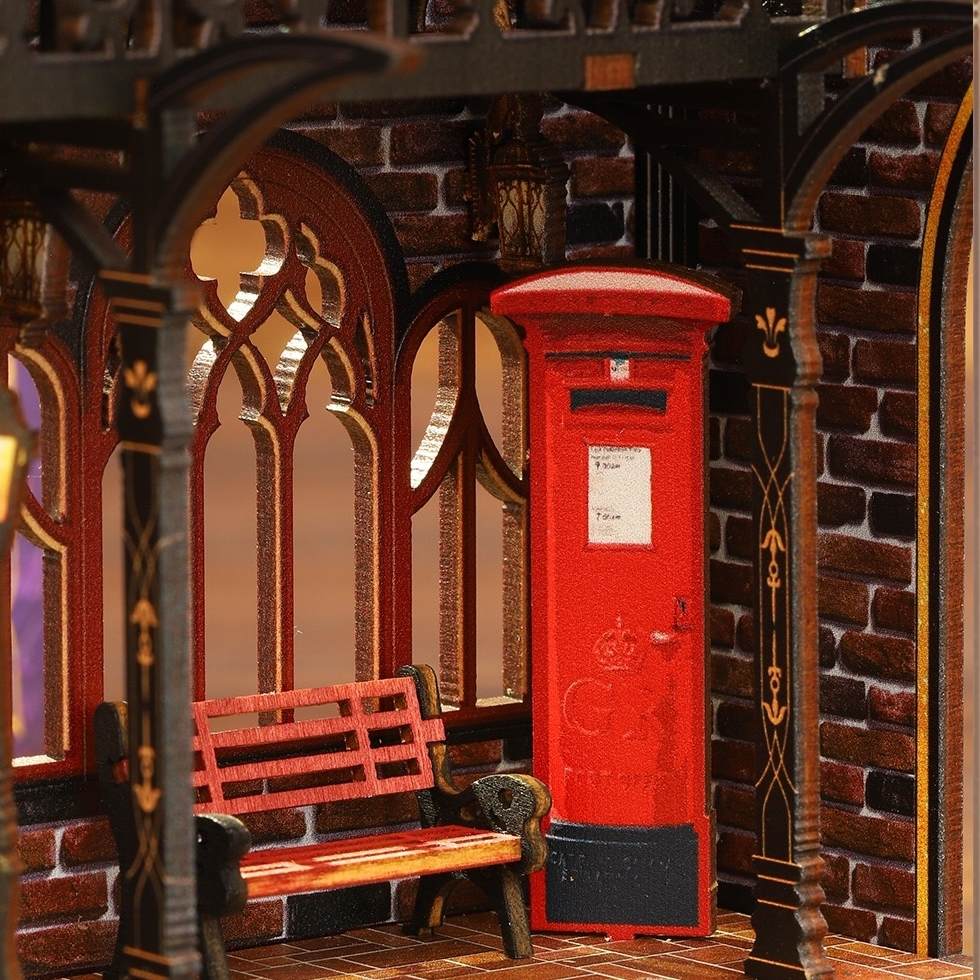 miniature Red mailbox and bench in a gothic-style room with brick walls.