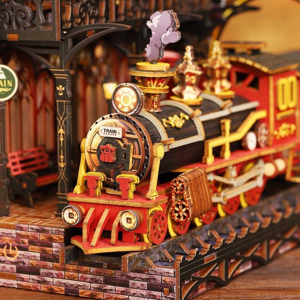 Detailed miniature model of a steam locomotive on tracks with intricate design elements.