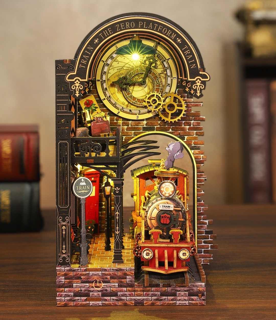 Detailed miniature book nook model of a train station platform with brick arch and mechanical elements.