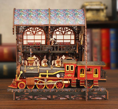 Detailed miniature model train set with stained glass roof on a wooden platform