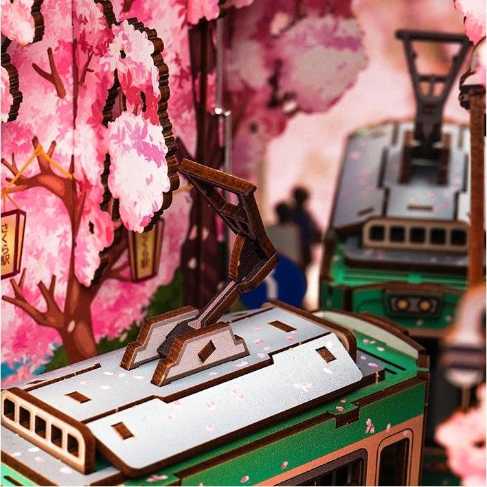 Japanese Sakura Densya DIY Book Nook Kit, A charming miniature 3d wooden puzzles the captures the essence of springtime in Japan, perfect for bookshelf decor or a delightful gift for Japanese culture lovers. 
